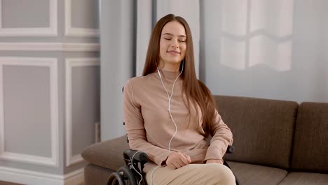 Young-disabled-woman-listening-music-at-home