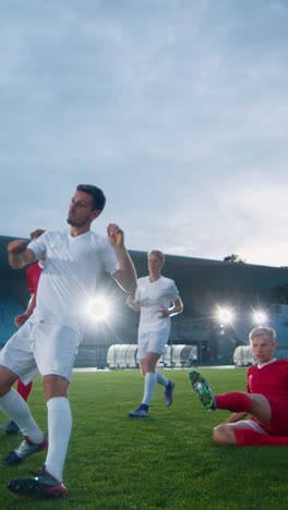 Professional-Soccer-Player-Outruns-Members-of-Opposing-Team-and-Kicks-Ball-and-Scores-Goal.-His-Team-Celebrates-Victory.-Video-Footage-with-Vertical-Screen-Orientation