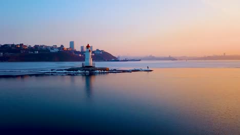 Aerial-winter-view-of-the-Tokarevskiy-lighthouse---one-of-the-oldest-lighthouses-in-the-Far-East,-still-an-important-navigational-structure-and-popular-attractions-of-Vladivostok-city,-Russia.