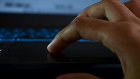 Close-up-shot-of-hands-of-a-female-using-laptop-via-touchpad