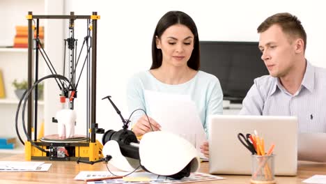 Positive-colleagues-working-sitting-at-the-table