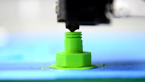 3D-printer-makes-or-printing-bolt-model,-screw-green-colour-close-up