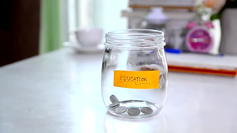 Falling-of-coins-to-glass-jar-concept-to-saving-money