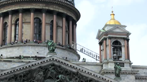 The-top-point,-people-climb-a-ladder,-the-dome-of-Saint-Isaac's-Cathedral-in-Saint-Petersburg,-Russia