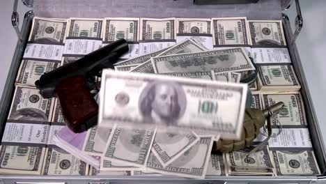 Case-full-of-dollars,-with-american-machine-gun.