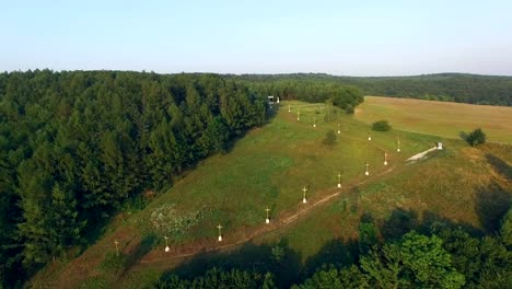 Aerial-shot-christian-crosses-along-the-path-on-the-hill