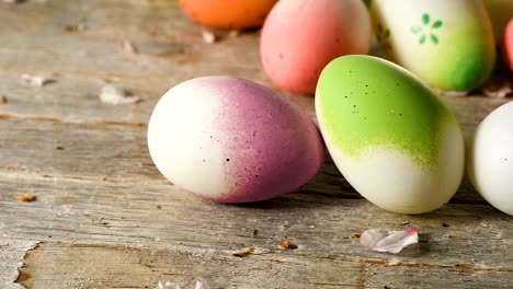 Easter-eggs-panning,-old-wooden-table-and-almond-blossom-petals