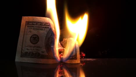 Dollar-bill-in-flames.-American-money-burning-on-black-background.