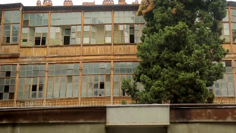 Aged-block-buildings-with-broken-windows,-abandoned-slum,-poor-damaged-area