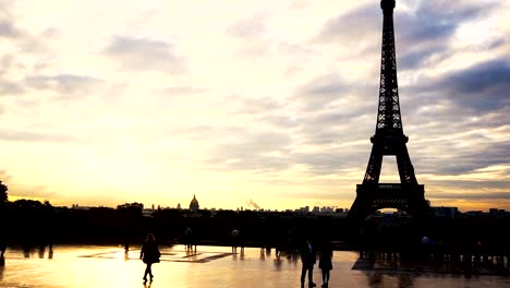 People-walking-near-Eiffel-Tower-with-cloudscape-background