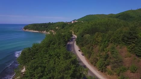 Video-aus-der-Drohne-fliegen-entlang-der-Küste.-Ein-Weg-führt-entlang-der-Küste.-Montains-und-Foresst-auf-der-Küste-des-Ozeans