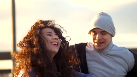 Portrait-of-happy-couple---disabled-man-in-wheelchair-talking-with-attractive-young-woman-enjoing-the-sunset