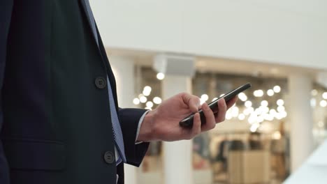 Businessman-Checking-Social-Media-Profile-on-Phone