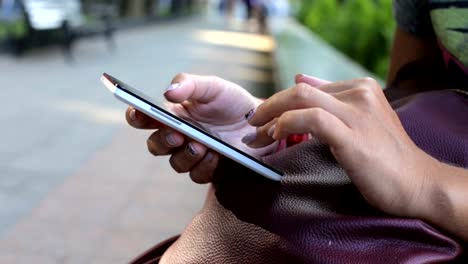 Girl-on-the-street-working-on-a-smartphone