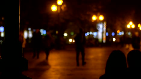 People-walking-in-the-evening-park.-Evening-city.-The-evening-lights-are-shining.