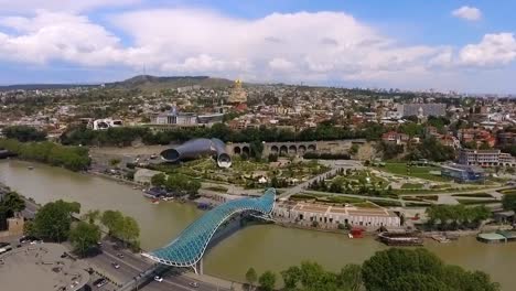 Bridge-of-Piece-in-Tbilisi,-futuristic-construction-in-modern-city,-aerial-view