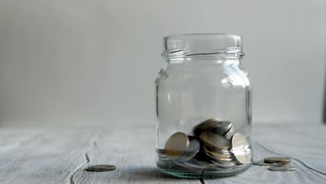 Coins-falling-into-the-jar.-Savings-in-the-jar