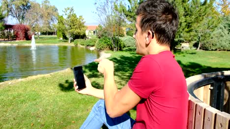 Young-boy-communicating-with-sign-language--at-smart-phone