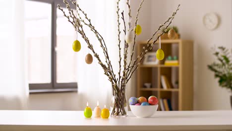 easter-eggs,-willow-and-candles-burning-at-home