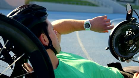 Disabled-athlete-using-smartwatch-on-a-running-track-4k