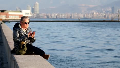 Middle-aged-woman-with-smartphone-at-the-outdoor