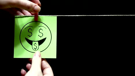 Two-stickers.-Emotions.-On-the-green-sheet-on-the-face-expression-love-of-money.-On-the-right-sheet-face-with-smile-and-good-nature.-Black-background.