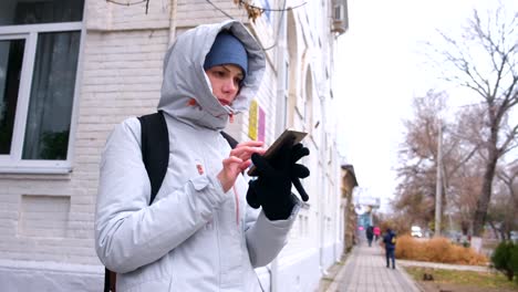 Woman-got-lost-in-the-city-and-looking-for-a-route-using-the-Navigator-in-the-mobile-phone.