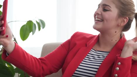 Happy-woman-doing-video-chat-using-mobile-phone