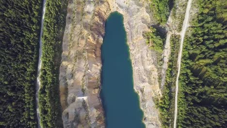 Hermosa-vista-desde-una-carretera-pasando-por-el-hermoso-lago-y-la-vista-superior-del-bosque.-pinza.-Árboles-y-carretera-cerca-del-lago.-Agua-verde.-Montañas