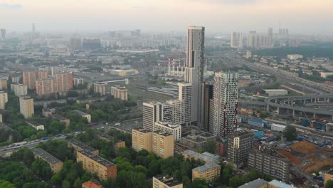 Aerial-view-of-the-skyscrapers-of-the-business-center-of-Moscow-and-highway-at-sunset