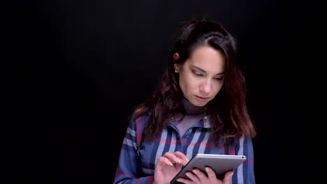 Closeup-portrait-of-young-beautiful-caucasian-female-using-the-tablet-then-looking-at-camera-and-smiling