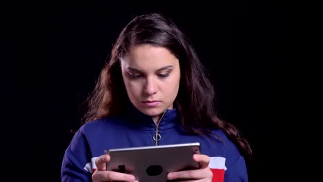 Closeup-portrait-of-adult-attractive-caucasian-female-typing-on-the-tablet-with-background-isolated-on-black