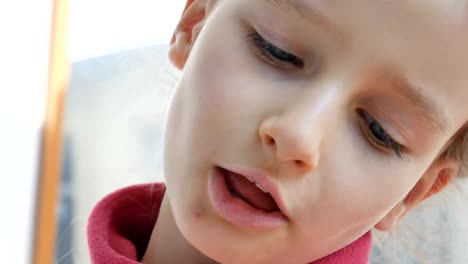 Close-up-portrait-of-a-pretty-little-girl-eating-bright-green-microgreens-of-sunflower.-Kids-and-nature,-vegetarian-concept,-healthy-eating