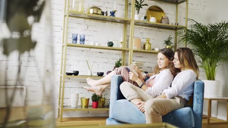 Girlfriends-reading-book-in-chair