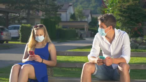 CLOSE-UP:-Man-scoots-away-from-woman-while-sitting-on-a-public-bench.