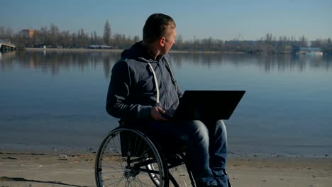 male-handicapped-leads-video-chat-on-laptop,-physically-disabled-man