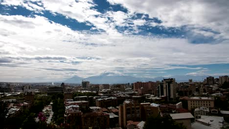 FullHD-Timelapse-of-clouds-above-the-city-with-huge-mountain-behind