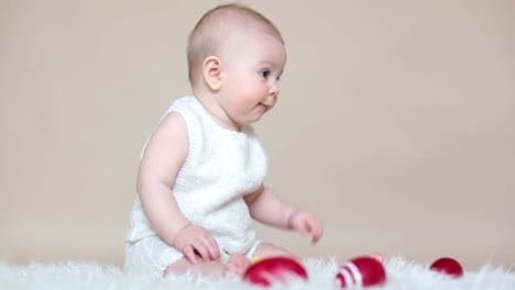 Cute-little-toddler-baby-boy,-playing-with-colorful-easter-eggs-and-little-decorative-ducks,-isolated-shot,-beige-background