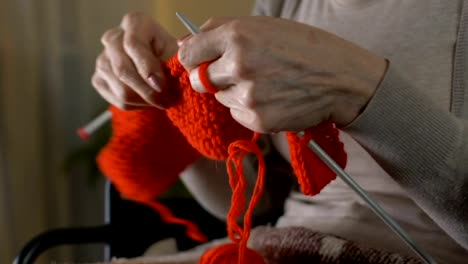 Lady-knitting-garment,-disabled-woman-hobby,-happy-and-secure-old-age,-free-time