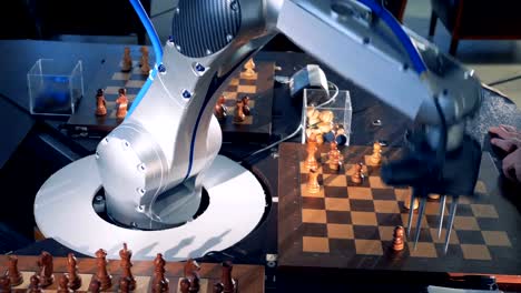 Close-up-robot-chessplayer-playing-chess-with-a-himan.