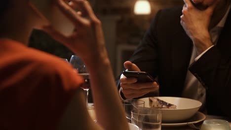 Couple-dining-together-and-ignoring-each-other