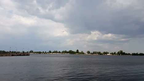 The-river-port-accepts-and-ships-the-cargo-across-the-water.-Mysterious-clouds-are-flying-very-low-over-river.