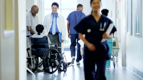 African-American-female-in-wheelchair-consult-with-staff