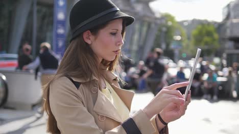 Young-attractive-Caucasian-woman-using-tablet-computer-at-train-station