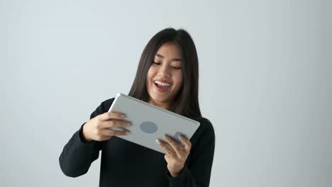 Happy-woman-playing-game-on-digital-tablet