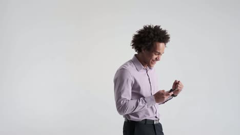 Businessman-using-mobile-phone-and-celebrating-success