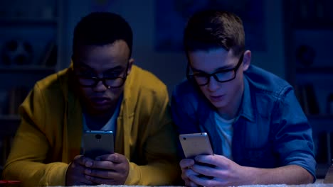 Multiracial-male-friends-surfing-net-late-at-night,-gadget-addiction,-eyesight