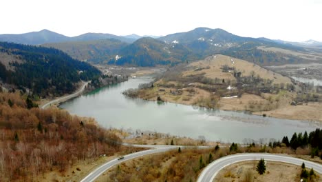 Bergsee-bei-bewölktem-Wetter-von-der-Drohne-entfernt-Schöne-Herbstlandschaft-mit-Wald-und-Bergen.