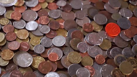 Many-different-coins-on-the-table.-Background-of-coins.