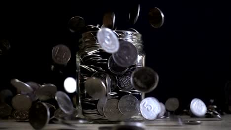 Ukrainian-coins-fall-into-a-jar.